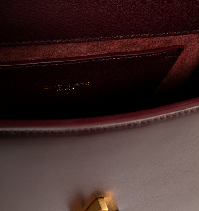 Image 3 of 3 - RED - SAINT LAURENT Solferino Mini Bag featuring box leather with a CASSANDRE closure, fully lined in leather, rounded lines, an adjustable strap for shoulder wear and bronze-tone hardware. 7.5" x 4.7" x 3". Calfskin. Made in Italy.