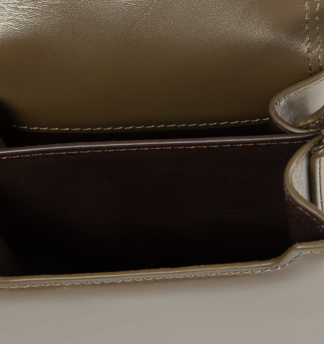 Image 3 of 3 - BROWN - LEMAIRE Small Calepin Bag featuring magnetic double closure, two main compartments, back flap pocket, nappa contrasted leather lining, silver logo embossed and adjustable shoulder strap. 4.5 x 7 x 2.2 inches. 100% calf. Lining: 100% lamb. Made in Spain. 