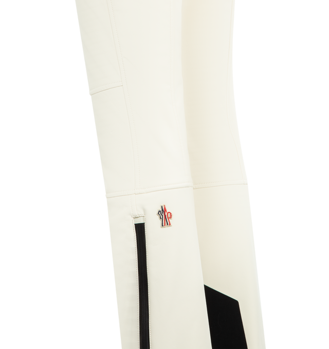 Image 3 of 4 - WHITE - MONCLER GRENOBLE Ski Pants featuring 3L 4-way stretch technical poplin, YKK AquaGuard highly water-resistant zipper and snap button closure, pockets with YKK AquaGuard highly water-resistant zipper closure, cuffs with YKK AquaGuard highly water-resistant zipper closure, powder cuffs, skicut hem protection and silicone logo. 68% polyester, 24% polyamide/nylon, 8% elastane/spandex. Made in Romania.