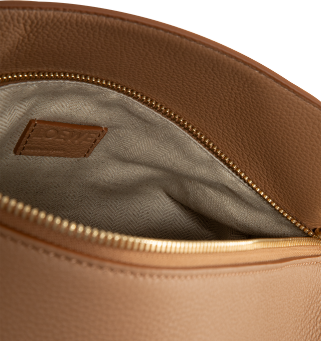 Image 3 of 3 - BROWN - LOEWE Medium Puzzle Edge Bag in soft grained calfskin featuring shoulder, crossbody or hand carry, detachable and adjustable strap, zip closure with calfskin pull, one external zip rear pocket, two internal slip pockets, herringbone cotton canvas lining and embossed Anagram. 7.7 x 11.4 x 5.5 inches. Soft grained calf. Made in Spain.