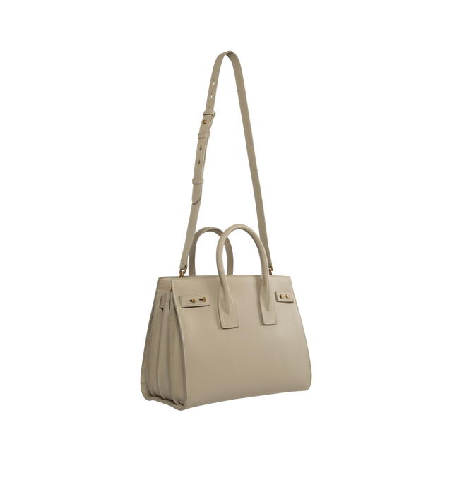 Image 2 of 2 - NEUTRAL - SAINT LAURENT Sac De Jour Small in Supple Grained Leather featuring suede lining, accordion sides, detachable padlock in leather case, interior zipped pocket, five metal feet and detachable shoulder strap. 12.5 X 10 X 6.1 inches. 95% calfskin leather, 5% metal. Made in Italy.  