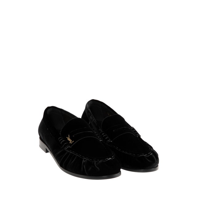 Image 2 of 4 - BLACK - Saint Laurent Men's Cassandre Velvet Penny Loafers are crafted from plush velvet and feature a supple silhouette with a hand-stitched moc toe for a refined finish. Designed with a classic penny loafer profile, these designer shoes are accented with the signature Cassandre in gold-tone brass hardware and finished with a leather sole and low stacked heel. Main Material: Velvet. Hardware: Brass. Sole: Leather. Heel Height: 1.5 cm / 0.6 in. Details: Gold-Tone Cassandre Hardware, Hand-Stit