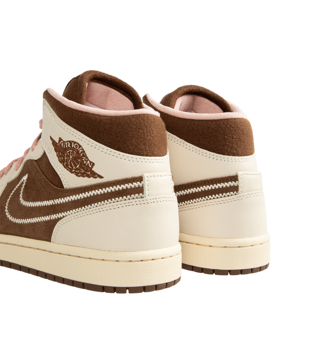 Image 3 of 5 - BROWN - Air Jordan 1 Mid Women's Shoes feature the iconic basketball-inspired silhouette and combine premium comfort with everyday wearability. Crafted with a durable leather upper, this classic style is equipped with an encapsulated Nike Air-Sole unit and a foam midsole for lightweight cushioning, while a rubber outsole provides reliable traction. Finished with a padded collar and traditional lace-up closure, the AJ1 Mid delivers timeless Jordan heritage with lasting support. Main Material: