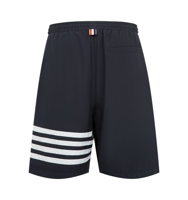Image 2 of 3 - BLUE - Thom Browne Mens Track Shorts are crafted from shiny ripstop fabric. Feature a relaxed fit, elasticized drawstring waistband with signature RWB aglets, zip fly, welt hand pockets, welt back pocket, mesh lining, engineered 4-bar detailing, and signature striped grosgrain loop tab. Main Material: 81% Polyamide, 19% Polyester; Lining: 100% Polyester. Made in Italy.