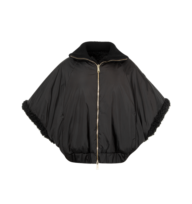 Image 4 of 4 - BLACK - MONCLER Reversible Faux Fur Cape featuring chunky knit collar, two-way zip-front, raglan sleeves, tonal leather logo patch on the left sleeve, relaxed fit, elasticized hem and reverses to a water-resistant recycled polyester. Polyester/leather. Lining: nylon.