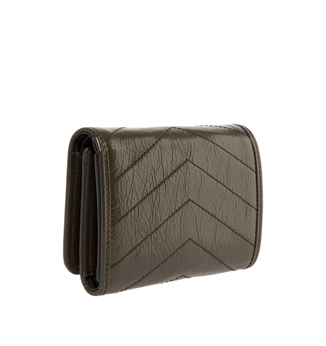 Image 2 of 3 - BROWN - Saint Laurent Womens Tri-Fold Wallet is crafted from calfskin leather. Features signature CASSANDRE hardware, quilted topstitching, snap-button closure, six card slots, one bill compartment, one zip coin pocket, and bronze-tone hardware. Dimensions: 12 11.5 2.5 cm. Main Material: Calfskin Leather; Hardware: Brass. Made in Italy.