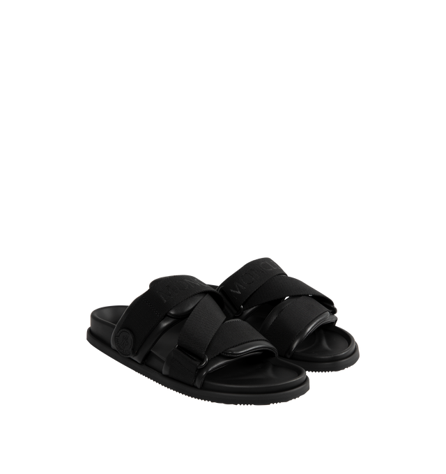 Image 2 of 4 - BLACK - MONCLER Mon Summer Leather Crisscross Sandals featuring crisscross logo-stamped polyester strap, flat heel, dual band upper, slip-on style, molded footbed, rubber outsole. Lining: leather. Made in Italy.