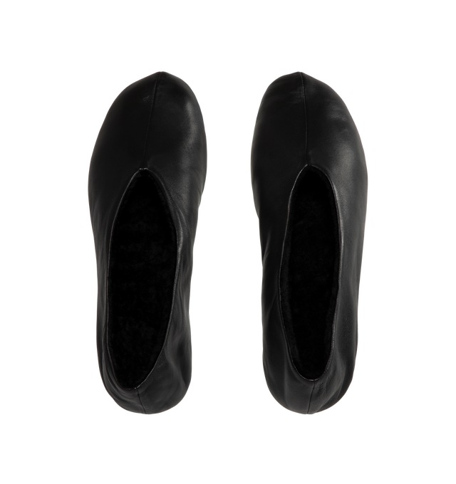 Image 4 of 4 - BLACK - The Row Women's Stella Slippers are crafted from smooth nappa lambskin leather and feature a slip-on silhouette with an oval toe, soft shearling lining, and a flexible rubber-coated sole. These designer leather slippers combine exceptional Italian craftsmanship with luxurious comfort, making them an elevated choice for effortless everyday wear. Main Material: 100% Lambskin Leather. Lining: Shearling. Sole: Rubber-Coated. Made in Italy.