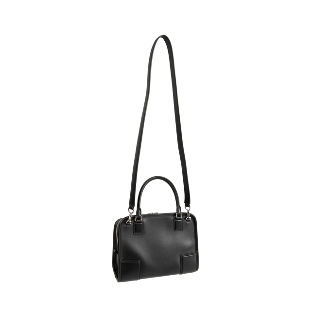 Image 2 of 5 - BLACK - Loewe Small Amazona 180 Bag in leather features a relaxed silhouette anchored by a single toron top handle, designed to be carried open, while a concealed closure secures the main compartment, three carry options: short handle, removable shoulder strap and crossbody, zip closure with two leather zip pullers, two compartments, main compartment closed with magnetic closure, internal flat pocket, left side d-ring for customization, nappa lambskin lining, and embossed double L branding. L