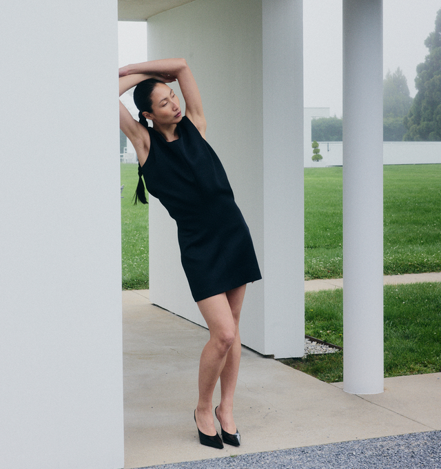 Image 2 of 5 - BLACK - KHAITE Toma Dress featuring a sculptural minidress that doubles as a tunic. Sharpened by clean shoulders and animated by bonded Italian crepe. Undulating bodice designed to blossom and bloom from slim-fitting skirt. Concealed zipper closure at back. 83% acetate, 17% viscose.