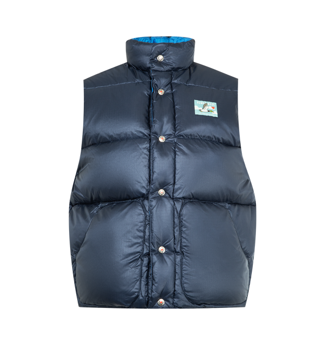 Image 1 of 3 - NAVY - HUMAN MADE Reversible Down Vest featuring nylon ripstop fabric with down and feather filling, lightweight material with a shiny appearance, reversible design combines dark and light colors, dark-toned side features a duck name tag, light-toned side has a heart patch, quilt stitching forms a heart on the back, both sides have two front pockets and logo snap button closure. 100% nylon.