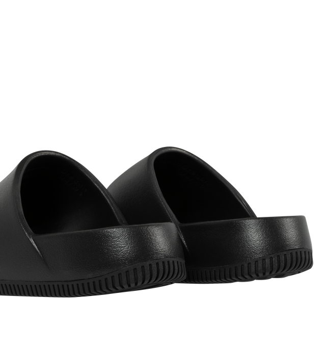 Image 4 of 5 - BLACK - NIKE Calm minimalist slides with debossed Nike Swoosh logo. Contoured foam composition is super soft with a responsive feel. The textured footed is for the stay-put foot placement. This shoe has a full-length rubber outsole for guaranteed grip on all surfaces with quick-drying design. 