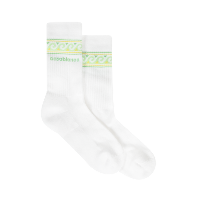 Image 1 of 2 - WHITE - CASABLANCA Knitted Wave Sport Socks featuring a wave border in green and yellow colourway, premium knit construction, ribbed cuffs and reinforced heel and toe construction. 85% recycled cotton 14% polyamide 1% elastane. Made in Portugal.