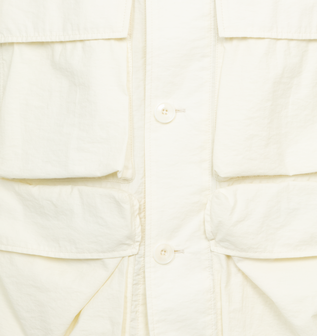 Image 3 of 6 - WHITE - LEMAIRE Light Field Jacket featuring relaxed fit, workwear collar, four 3D pockets, buttoned tabs at the cuffs, back yoke, corozo buttons, bottom of the jacket is elasticated in the back and unlined. 84% cotton, 16% polyamide. 