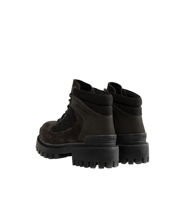Image 3 of 4 - BROWN - Balenciaga Men's Combat Strike Low Boot is crafted from nubuck calfskin, suede calfskin, and cotton canvas and features an extra-round toe, a six-eyelet lace-up vamp, visible topstitching, and a worn-effect finish. Designed with a thick toothed rubber outsole, this low-profile combat boot is finished with Balenciaga logo detailing at the exterior, front, and back. Main Material: Calfskin leathers and Sole: TPU, Polyurethane. Heel Height: 20 mm / 0.8 in. Made in Italy.