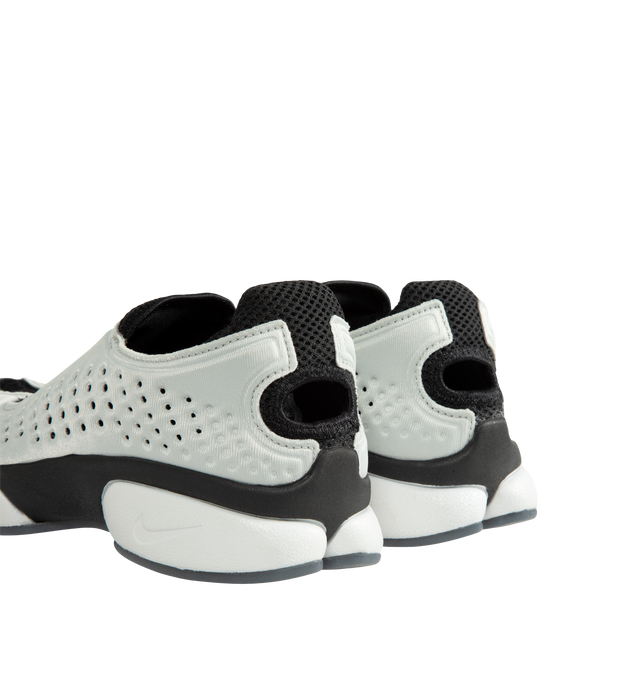 Image 3 of 5 - WHITE - Nike Women's Rift II Sneakers are a one-to-one reissue of the sought-after 2002 update to the iconic Air Rift and feature a streamlined slip-on silhouette, a flexible upper with breathable mesh underlays, and the signature split-toe design. This lightweight sneaker revives a cult-favorite look while maintaining the performance-inspired details that made the original a standout. Main Material: Textile and Synthetic Upper with Mesh Underlays.