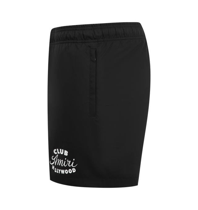 Image 3 of 4 - BLACK - AMIRI Club Amiri Swim Trunk featuring logo on leg, elastic waistband with drawstring, side seam pockets and back pocket with flap. 100% polyester.