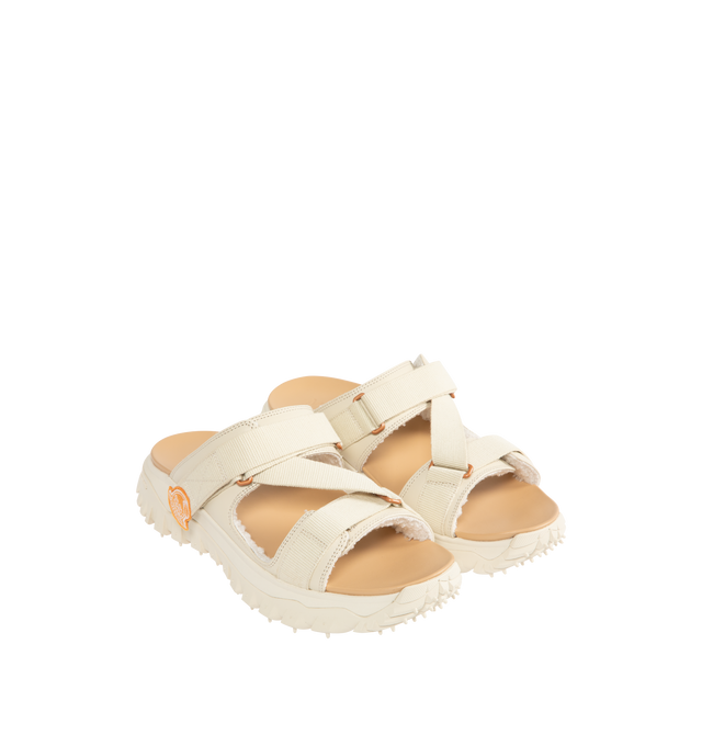 Image 2 of 4 - WHITE - Moncler x Gilga Farm Designed by Donald Glover Trailgrip Vela Leather Sandals featuring upper in leather and cotton, faux fur insole, EVA midsole, special Vibram MEGAGRIP rubber compound tread, EVA ergonomic insole and strap closure. Sole height 4.5 cm. Upper: 100% cotton. 100% cow. Lining: 100% polyester. Sole: 100% elastodiene. Made in Vietnam.