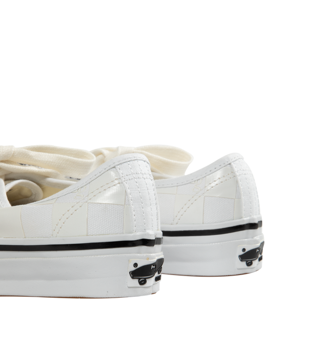Image 3 of 5 - WHITE - VANS X HOMME GIRLS OTW Authentic 44 Sneaker featuring Heritage low-top shoe, Style 44, 8 oz canvas upper with 6 oz canvas bindings and heel strip, HommeGirls branded lace, with optional second lace, metal eyelets, higher sidewall with gloss finish, foxing tape, reinforced outsoles, Co-branded Foam ADC (All-Day Comfort) insole, signature waffle outsole pattern, all-over checkerboard pattern with Hg monograms and co-branded logo heel scab.