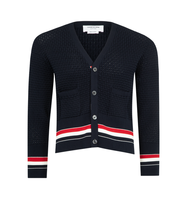 Image 1 of 3 - NAVY - THOM BROWNE Float Ripple Stitch Cardigan featuring high-twist cotton with a float ripple stitch, V neckline, front button closure with RWB grosgrain placket, patch hand pockets with ribbed trim, buttoned cuffs and side vents with RWB grosgrain trim, engineered RWB detailing and signature striped grosgrain loop tab. 100% cotton. Made in Italy.