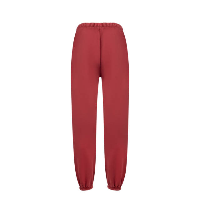 Image 2 of 3 - RED - FEAR OF GOD ESSENTIALS Heavy Fleece Classic Sweatpant featuring 520gsm heavy cotton fleece, pigment-dyed, relaxed silhouette tapers into an elastic hem, HD-printed Fear of God Essentials lockup, encased elastic waistband with elongated drawcords, side seam pockets and a Fear of God Essentials rubberized label stitched at the center front. 100% cotton.
