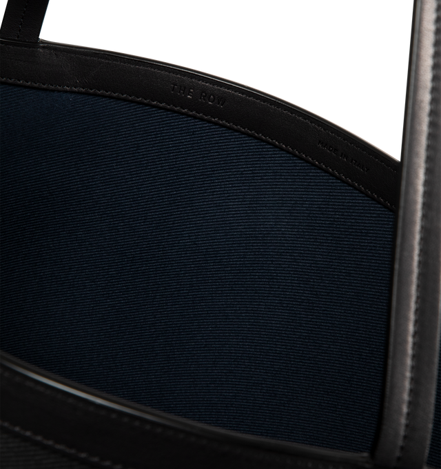 Image 3 of 3 - BLACK - THE ROW Park Tote Three Canvas Bag featuring classic tote bag in textured cotton twill with interior toggle closure, saddle leather trim and interior wristlet with adjustable strap. 85% cotton, 15% calfskin leather. Lined in 100% cotton. Made in Italy.
