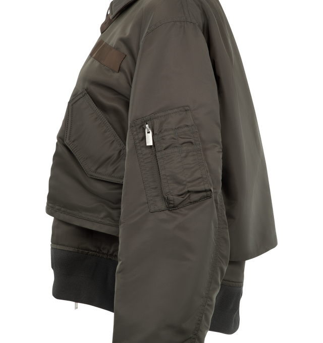 Image 3 of 4 - BROWN - Sacai Nylon Twill Blouson is crafted from nylon twill with lightweight padding. Features a blouson silhouette, mixed-media paneling, full lining, and modern utility-inspired construction. Outer: 100% Nylon; Parts: 55% Polyester, 44% Cotton, 1% Polyurethane; Lining: 100% Polyester; Filling: 100% Polyester. Made in Japan.