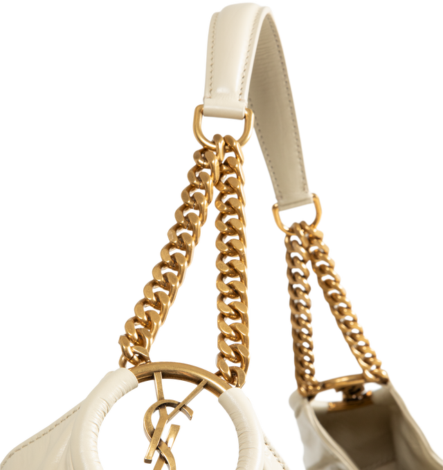 Image 4 of 4 - NEUTRAL - Saint Laurent Womens Hobo Bag is crafted from lustrous calfskin leather. Features a slouchy silhouette, signature Cassandre ring detail, shoulder strap, magnetic closure, removable zip pouch, suede lining, and bronze-tone hardware. Main Material: Calfskin Leather; Lining: Suede; Hardware: Brass. Made in Italy.