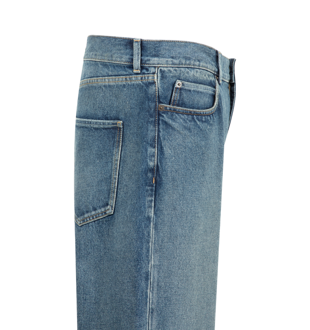 Image 3 of 3 - BLUE - The Row Men's Vanya Jeans are crafted from cotton denim and feature a mid-rise silhouette with a wide leg, contrast topstitching, and classic five-pocket construction. The denim undergoes a brushed treatment to create a naturally aged appearance, followed by a light indigo overdye that enhances tonal variation and adds richness to the color. Main Material: 100% Cotton. Fit: Mid-Rise, Wide Leg. Details: Contrast Topstitching and Five-Pocket Construction. Made in Japan.