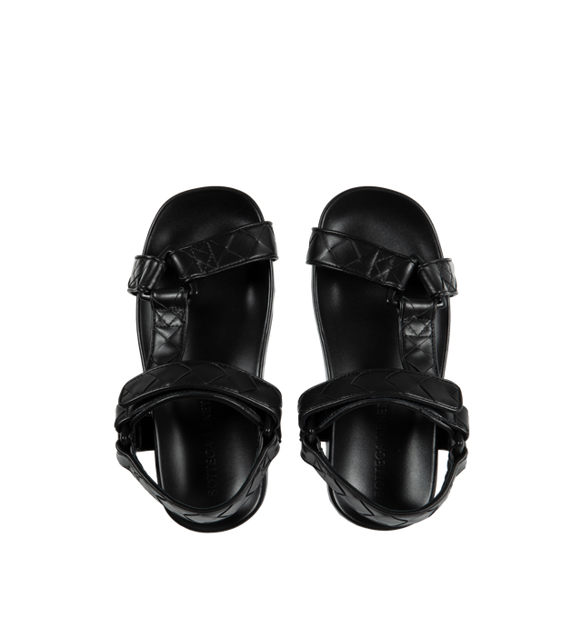 Image 4 of 4 - BLACK - BOTTEGA VENETA Leather Flat Sandals featuring ergonomic sculpted insole, round toe, VELCRO strap closure and signature intrecciato woven-pattern upper. Leather upper and lining, synthetic sole. Made in Italy. 