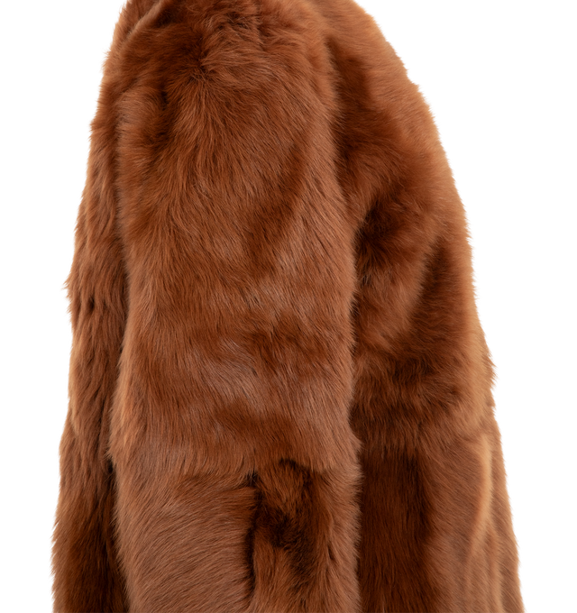 Image 3 of 3 - ORANGE - Toteme Women's Short Silky Shearling Coat Ginger is a statement coat made from soft lamb shearling with long silky hairs for a dramatic take on texture. It has a round neckline, side-seam pockets, and concealed hooks for a clean finish. Main Materials: Lamb shealing/leather, Suede interior.