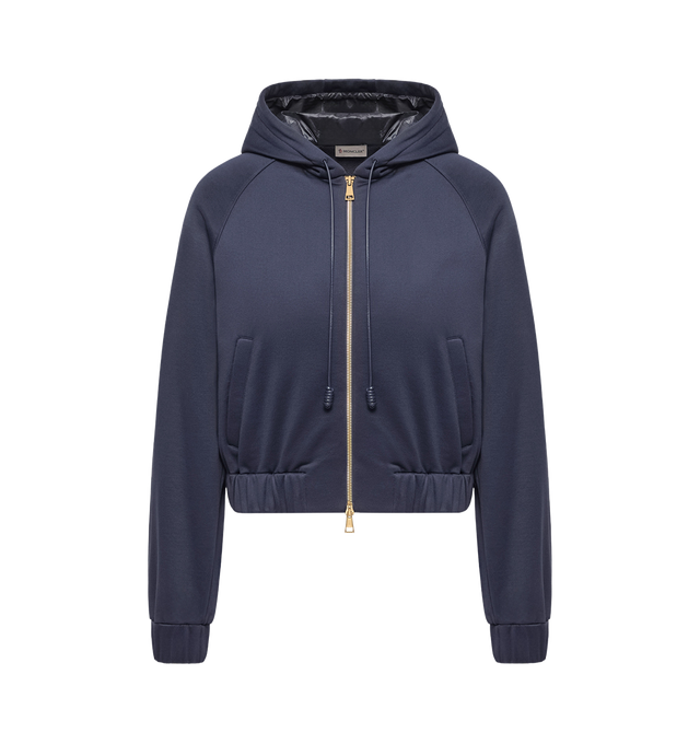 Image 1 of 1 - BLUE - Moncler Womens Technical Fleece Zip-Up Cardigan is crafted from technical fleece and features a relaxed silhouette, fixed hood with Longue Saison lining, zip-front closure, front pockets, and a signature logo patch. This designer zip-up cardigan combines soft fleece construction with lightweight performance detailing for comfortable everyday layering. Main Material: 55% Polyamide, 42% Cotton, 3% Elastane; Hood Lining: 100% Polyamide. Made in Italy.