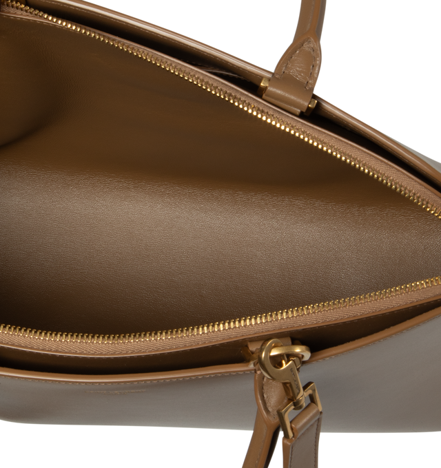 Image 3 of 4 - BROWN - SAINT LAURENT Sac De Jour Duffle featuring brass padlock, embossed logo, leather lining, two compartments separated by a zip pouch, top handle, adjustable shoulder strap and four metal feet. 14.4 X 8.7 X 0.4 inches. Calfskin leather. Made in Italy.  