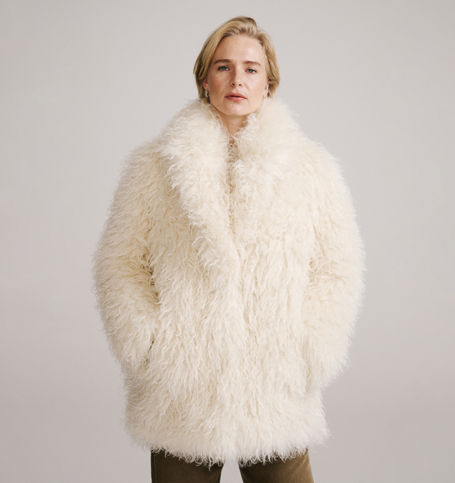 Image 2 of 4 - CREAM - Moncler Grenoble Women's Malencos Padded Short Jacket is crafted from plush faux fur and features a sophisticated peacoat-inspired silhouette with oversized lapels and lightweight padding for warmth. Inspired by the brand's mountaineering heritage, this textured outerwear style blends elevated alpine design with everyday comfort. Finished with a snap-button front closure, side pockets, an interior media pocket with a YKK AquaGuard NATULON water-repellent zipper, and stretch jersey wri
