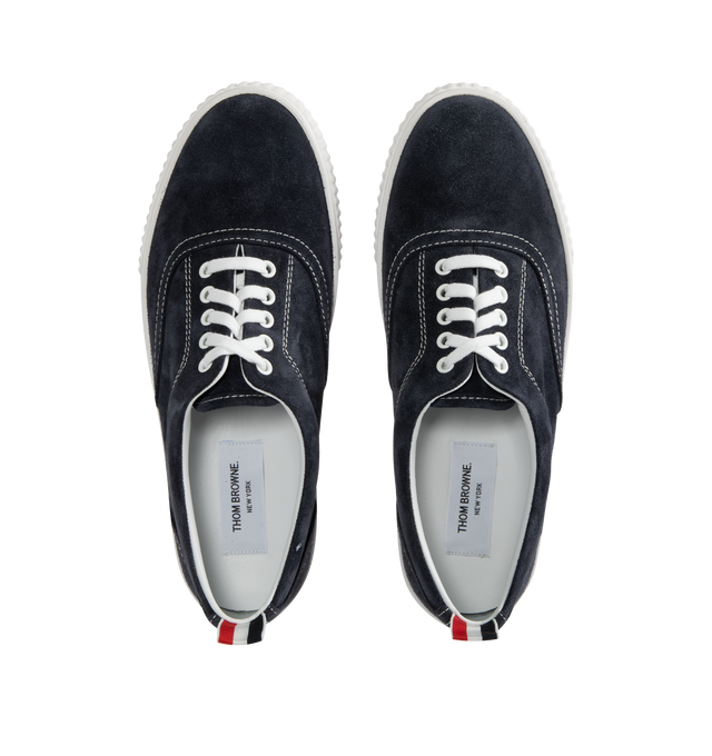 Image 5 of 5 - NAVY - THOM BROWNE Suede Heritage Trainer featuring lace up closure, rubber sole, leather lining and signature striped grosgrain loop tabs. Suede leather. Made in Italy.