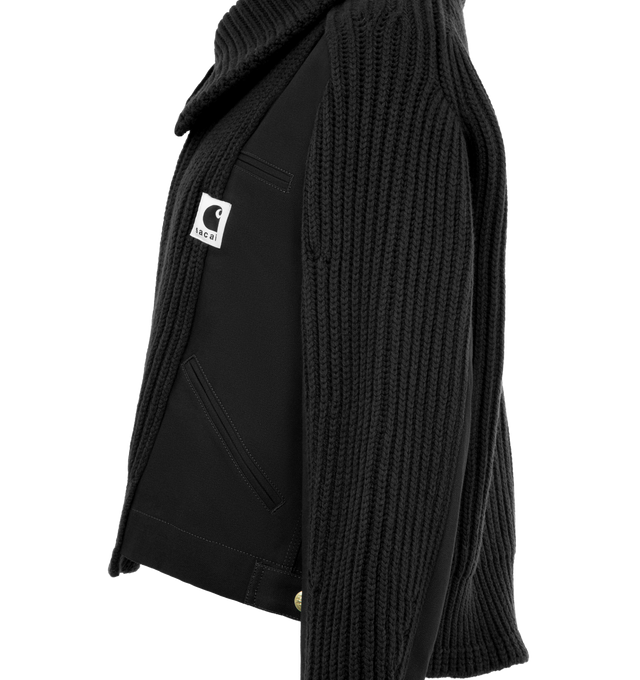 Image 3 of 4 - BLACK - Sacai x Carhartt WIP Women's Duck x Wool Knit Blouson is a hybrid of Carhartt WIPs Detroit Jacket and sacais knit blouson. Featuring two front layers on the body and sleeves, made from Carhartt WIPs duck canvas fabric, with rib-knit, spun wool and nylon yarn, an asymmetric front opening with a double zipper, and a high neck that can be worn up or down to form a flat collar, and co-branded woven label. A co-branded woven label appears on the front. Organic cotton canvas, Knit material