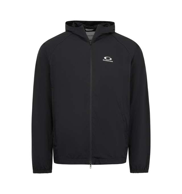 Image 1 of 3 - BLACK - BALENCIAGA Technical Tracksuit Jacket featuring technical polyamide, hooded design, high neck, double-ended zip fastening, long raglan sleeves, contrasting piping, 2 zipped slash pockets, 2 inner vertical zipped pockets, loop sports icon artwork embroidered on chest, adjustable drawstring at hem and elasticated cuffs. 100% polyamide. Lining: 100% polyester. Made in Italy.