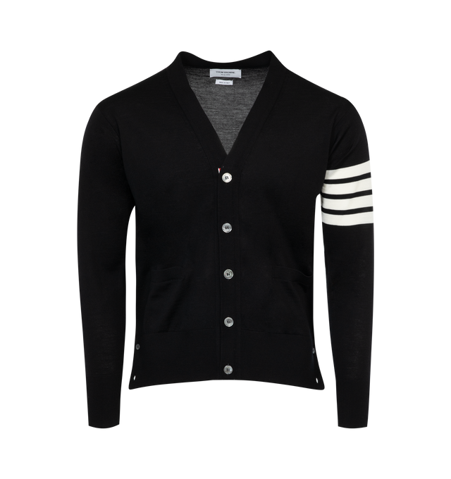 Image 1 of 2 - BLACK - THOM BROWNE long sleeve knit merino wool cardigan with ribbed collar, cuffs, and hem. Button closure featuring concealed signature tricolor grosgrain trim at front. Welt pockets at waist. Signature stripes in white at sleeve. 100% Merino Wool. 
