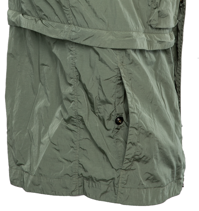 Image 7 of 7 - GREEN - C.P. COMPANY Chrome-R Goggle Utility Jacket featuring acetate lenses with press-stud fastening at detachable hood, bungee-style drawstring at hood and hem, two-way zip closure wit press-stud placket, flap pockets, seam pockets and adjustable press-stud fastening at cuffs. 100% recycled polyamide. Lining: 100% cotton. Made in China. 