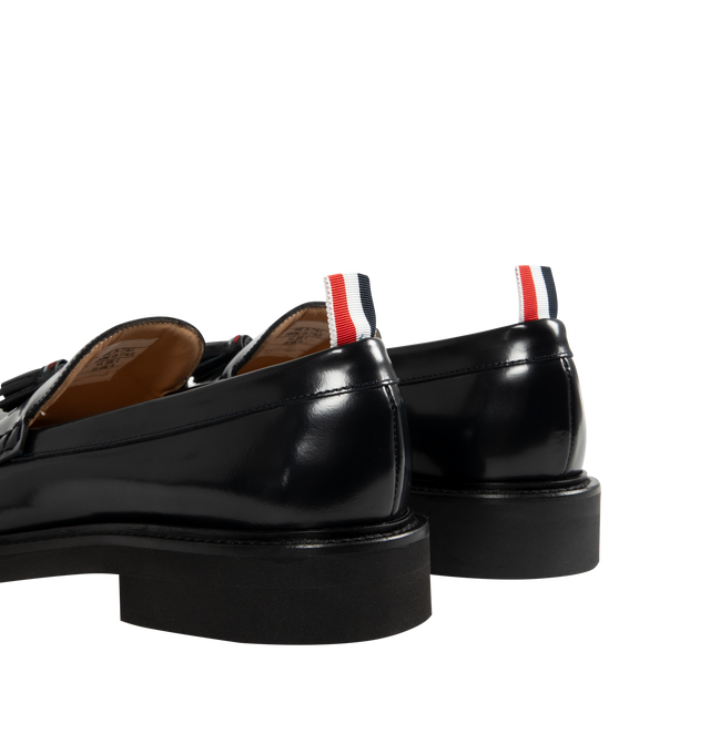 Image 3 of 4 - NAVY - THOM BROWNE Spazzolato Leather Tassle Loafer featuring classic penny loafers with red, white, and blue trim at the tassels, slip on and signature striped grosgrain loop tabs at heels 100% calf leather. Sole: 100% rubber. Lining: 100% calf leather. Made in Italy.