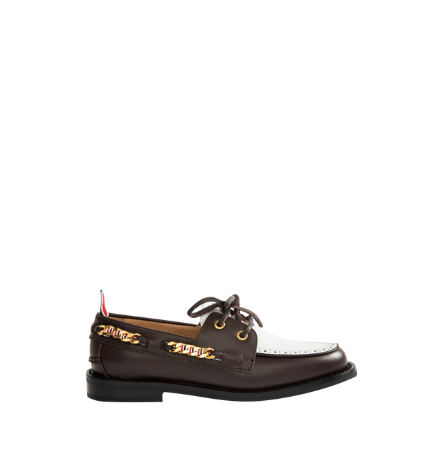 Image 1 of 4 - BROWN - THOM BROWNE Brogue Leather Boat Shoes featuring two-tone leather with a refined brogue-style perforated panel, classic silhouette, a chain-link trim interwoven with the houses signature stripes, almond toe, slips on, leather upper, leather lining and rubber sole. Made in Italy.