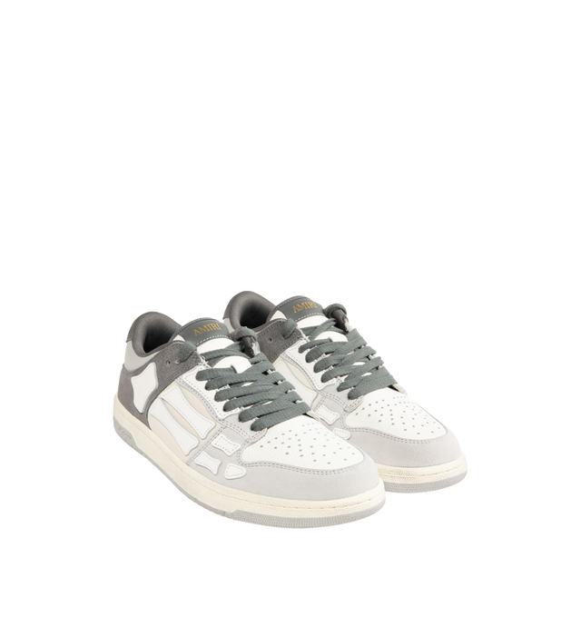 Image 2 of 5 - GREY - AMIRI Distressed Skel-Top Low Sneakers featuring appliqus throughout, perforated detailing at toe, lace-up closure, logo patch at padded tongue, padded collar, logo embossed at heel tab and treaded rubber sole. Upper: synthetic, leather. Sole: rubber.
