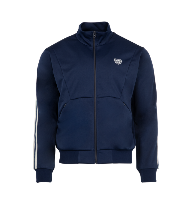 Image 1 of 3 - NAVY - HUMAN MADE Track Jacket featuring zip front closure, stand collar, a heart logo in thick flocky print, an embroidered logo on the front and jacquard tape on both sleeves. 100% polyester.