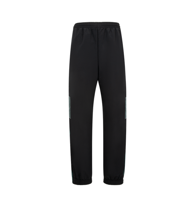 Image 1 of 3 - BLACK - MARTINE ROSE Paneled Nylon Track Pants featuring regular fit, elasticated drawstring waistband, two side zip pockets, contrasting side panels, embroidered logo and elasticated and zipped cuffs. 100% nylon.