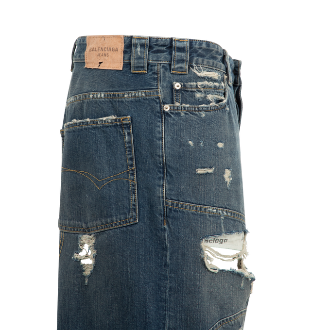 Image 3 of 3 - BLUE - BALENCIAGA Distressed Baggy Shorts featuring cotton denim, extreme destroyed details, mid-waist, covered button fly, 5 belt loops, 5 pockets, visible lining pockets, Balenciaga engraved flex buttons and Balenciaga Jeans jacron at back. 100% cotton. Made in Italy.