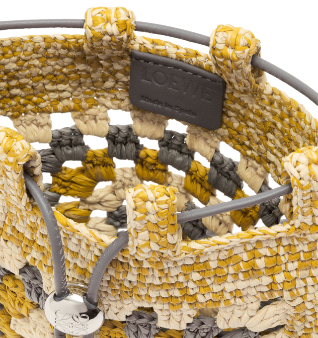 Image 4 of 5 - MULTI - LOEWE PAULA'S IBIZA Drawstring pocket in classic calfskin and raffia featuring a classic calfskin strap adjustable via an Anagram Pebble dice and a contrast LOEWE embroidery, shoulder or crossbody carry, unlined and engraved Anagram. Raffia/calf. 21 cm x 16 cm x 1 cm. Made in Spain.