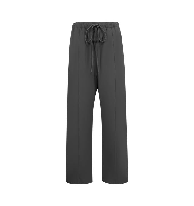 Image 1 of 3 - GREY - FEAR OF GOD ESSENTIALS Relaxed Track Pants featuring a drawstring waistband with long drawstrings, side hand pockets, wide leg openings with ankle zipper closures, seam details down the front legs, a silicone rubberized brand label on the front, a soft-touch Fear of God ESSENTIALS logo graphic down the leg and a baggy relaxed fit. 84% nylon, 16% spandex.
