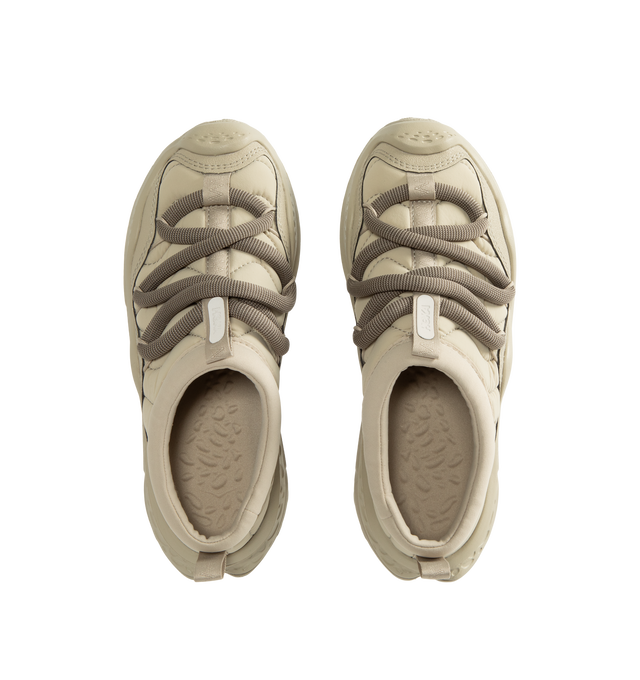Image 5 of 5 - NEUTRAL - Hoka Unisex Ora Primo Sneaker featuring soft knit collar, insulated puff upper, slip-on style, zig-zag stitch detail, round elastic lace system and protective toe bumper. Nylon, textile. Rubber sole. *Unisex style in men's sizing.
