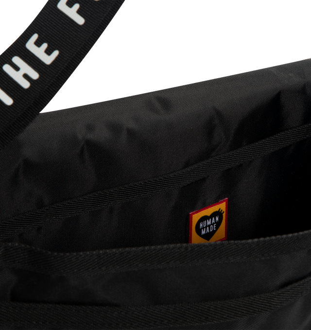 Image 4 of 4 - BLACK - HUMAN MADE Shoulder Bag featuring shoulder bag with a buckle belt, lightweight and durable nylon Oxford fabric, PVC heart logo on the front, shoulder strap with logo, zip pocket on the back, two pockets provide storage for small items and A4-sized storage. 100% nylon.