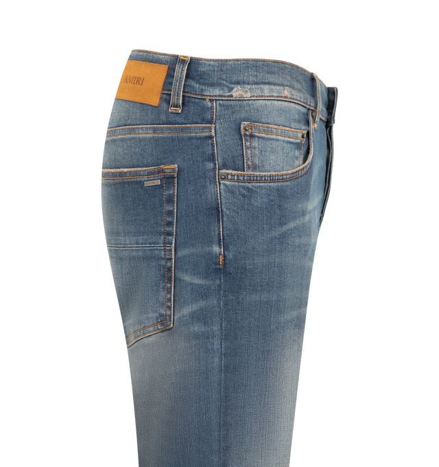 Image 3 of 3 - BLUE - Amiri Men's MX1 Jeans from the Autumn-Winter 2026 collection are crafted from stretch cotton denim and feature the house's iconic hand-distressed construction, repaired with python-embossed leather for a signature textured finish. Designed with classic five-pocket detailing, these designer jeans undergo a specialized treatment that creates intentional variations in shading and color, giving each pair a distinctive character. Main Material: 92% Cotton, 6% Elastomultiester, 2% Elastane.